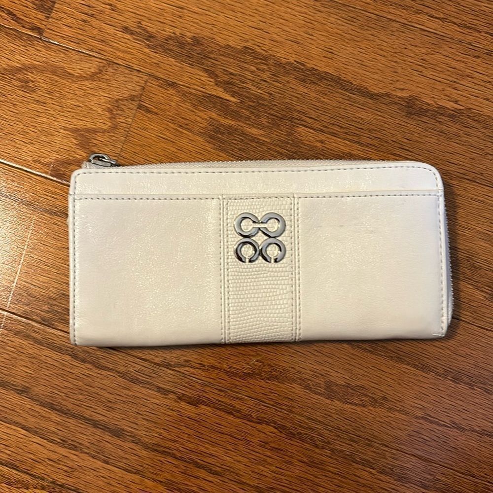 Cream zippered ivory wallet with numerous pockets and zippers.  NWOT